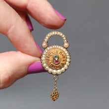 Load image into Gallery viewer, Antique Victorian era padlock brooch with pearl border, and keyhole set with a ruby and emerald. Inscribed with the Latin motto Coer Souvenir meaning Remember the Heart. With a dangling gold heart and hair in glass compartment. Anniversary gift. Wedding gift.