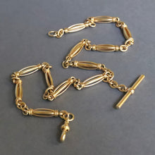 Load image into Gallery viewer, Antique Albert chain. Antique Victorian watch chain in 9ct yellow gold with fancy links. Heavy gold chain. Oval links. Floating T-bar fob. Dog clip closure. Medium length gold chain.