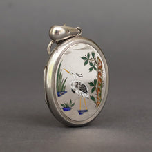 Load image into Gallery viewer, Antique Aesthetic movement locket dating to the Victorian era with engraved wading stork and songbird in multicoloured enamel. Oval locket. Birth present. Baby gift. Push present.