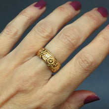 Load image into Gallery viewer, Antique Edwardian era wide gold stacking band ring in 9ct gold. Antique wedding ring with pansy and ivy leaf design around circumference. Ivy leaf symbolising fidelity, loyalty, devotion. Pansies for loving thoughts. Anniversary gift ring.