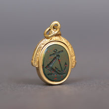 Load image into Gallery viewer, Antique bloodstone spinner fob pendant with intaglio depicting and knight's armored arm rising from the water holding an anchor. The monogram initials on the other side are MJ. Has a gold frame engraved and made from 18ct gold.