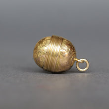 Load image into Gallery viewer, Antique Victorian era oval-shaped pendant in 15ct gold with repousse and foliate engraving. Locket spins to reveal hidden secret glass compartment.