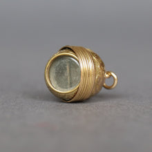 Load image into Gallery viewer, Antique Victorian era oval-shaped pendant in 15ct gold with repousse and foliate engraving. Locket spins to reveal hidden secret glass compartment.
