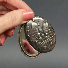 Load image into Gallery viewer, Antique art nouveau slide locket with double sided mirror. Locket with lily of the valley decoration. Large art nouveau silver locket. Repousse art nouveau locket.