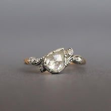Load image into Gallery viewer, An antique diamond ring featuring a large pear-cut diamond set in a silver cut down collet with foil back and small accent diamonds and a gold band. Perfect engagement ring.