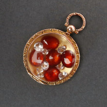 Load image into Gallery viewer, Antique Edwardian era locket in 9ct gold with garnets & sapphires