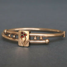 Load image into Gallery viewer, Antique Victorian era bypass bangle with garnets in 10ct gold casing