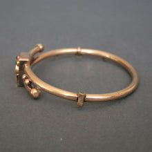 Load image into Gallery viewer, Antique Victorian era bypass bangle with garnets in 10ct gold casing