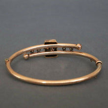 Load image into Gallery viewer, Antique Victorian era bypass bangle with garnets in 10ct gold casing