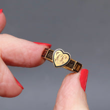 Load image into Gallery viewer, An antique gold mourning ring with a heart-shaped face engraved with a monogram CS and a band featuring black enamel sections with the words ‘In Memory Of’ and hairwork.
