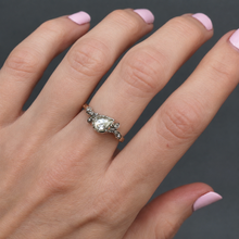Load image into Gallery viewer, An antique diamond ring featuring a large pear-cut diamond set in a silver cut down collet with foil back and  small accent diamonds and a gold band. Perfect engagement ring.
