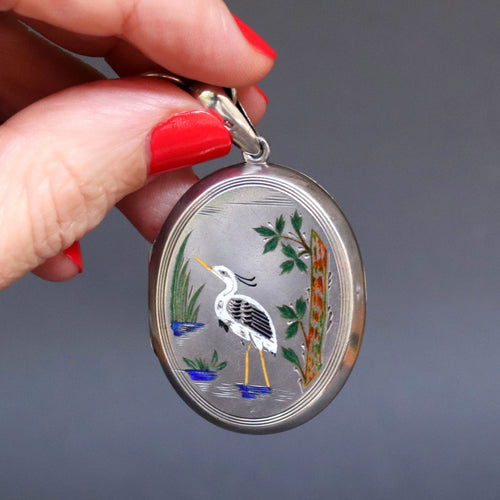 Antique Aesthetic movement locket dating to the Victorian era with engraved wading stork and songbird in multicoloured enamel. Oval locket. Birth present. Baby gift. Push present.