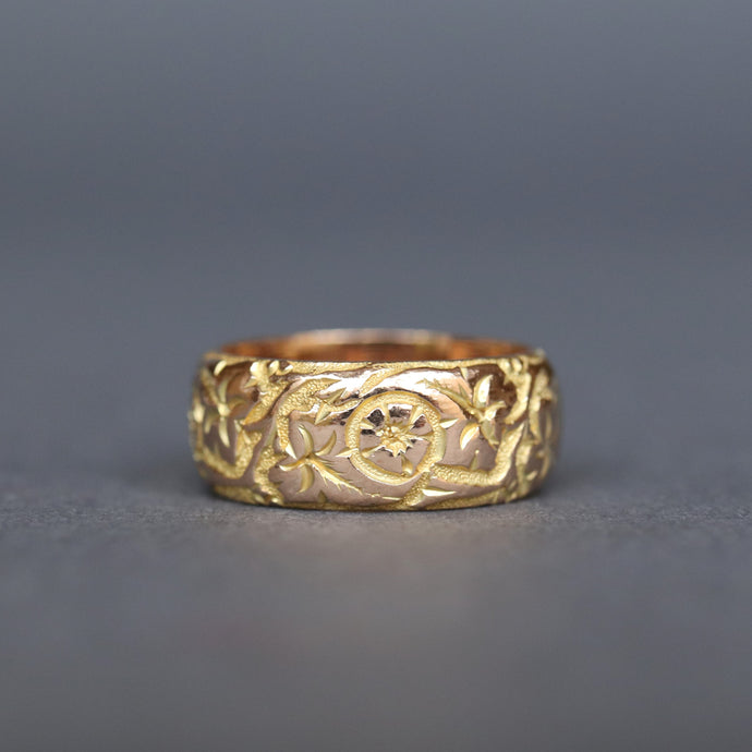 Antique Edwardian era wide gold stacking band ring in 9ct gold. Antique wedding ring with pansy and ivy leaf design around  circumference. Ivy leaf symbolising fidelity, loyalty, devotion. Pansies for loving thoughts. Anniversary gift ring.