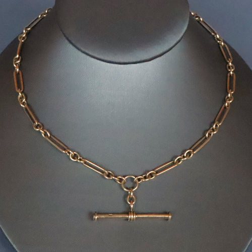 Vintage antique fetter link Albert watch chain in 9 carat yellow gold with t-bar fob and double dog clips. Double swivel clips. Antique vintage trombone link chain.