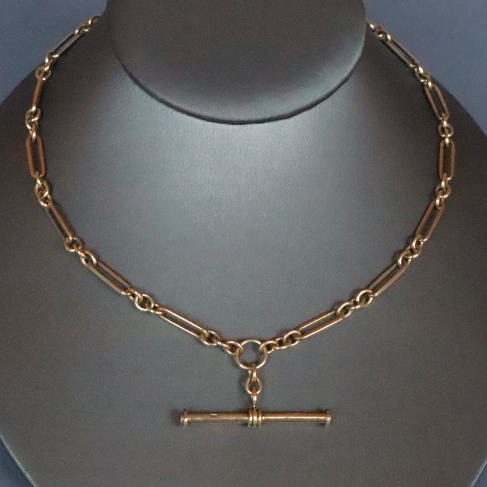 Vintage antique fetter link Albert watch chain in 9 carat yellow gold with t-bar fob and double dog clips. Double swivel clips. Antique vintage trombone link chain.