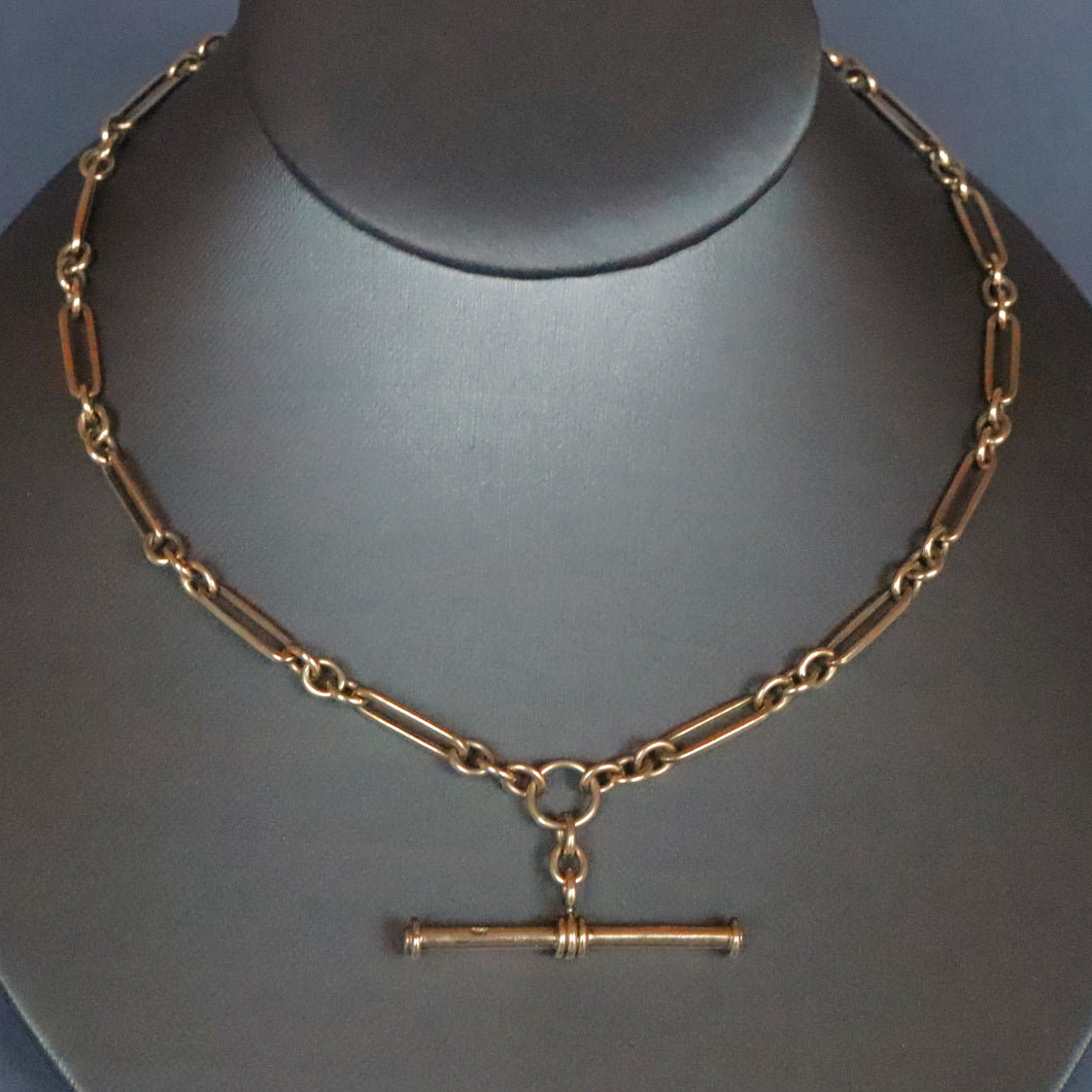 Vintage antique fetter link Albert watch chain in 9 carat yellow gold with t-bar fob and double dog clips. Double swivel clips. Antique vintage trombone link chain.