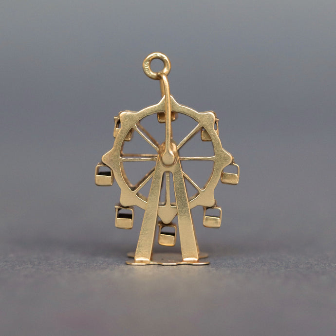 Vintage spinning ferris wheel charm in 14ct 14k yellow gold. Articluated ferris wheel pendant. Ferris wheel spins and cars carts swing. Whimsical gold charm.