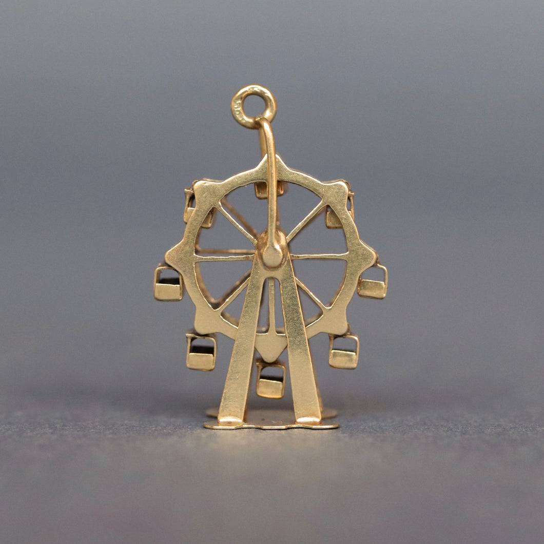 Vintage spinning ferris wheel charm in 14ct 14k yellow gold. Articluated ferris wheel pendant. Ferris wheel spins and cars carts swing. Whimsical gold charm.