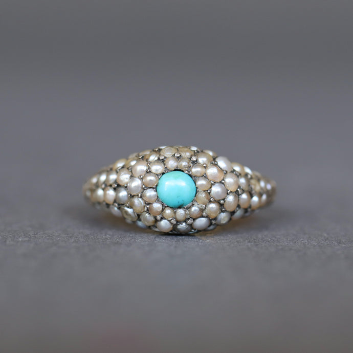 Antique Victorian era cluster ring with seed pearls and cabochon cut blue turquoise to a 14ct yellow gold band with a domed profile.