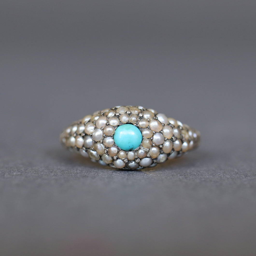 Antique Victorian era cluster ring with seed pearls and cabochon cut blue turquoise to a 14ct yellow gold band with a domed profile.