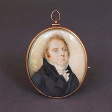 Load image into Gallery viewer, Antique Georgian era portrait miniature, hand-painted and finely detailed. Depicts a middle-aged gentleman in topcoat and cravat with cock-eyed appearance. Oval rose-gold frame with brooch and pendant fittings.
