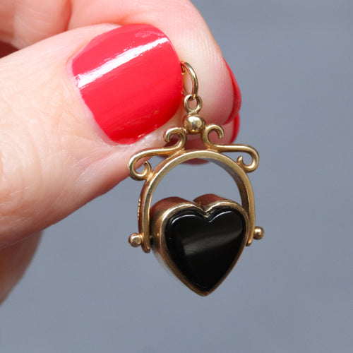 Vintage heart-shaped spinner fob pendant with rotating heart set with onyx and bloodstone in a 9ct yellow gold arched frame.