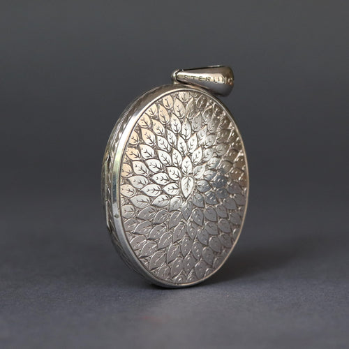 Large antique Victorian era oval shaped locket with leaf design and monogram CM or MC in sterling silver.