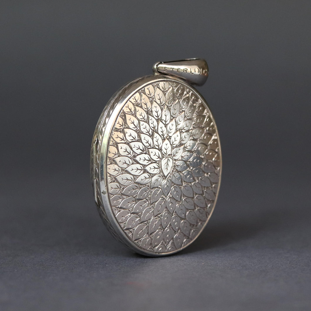 Large antique Victorian era oval shaped locket with leaf design and monogram CM or MC in sterling silver.