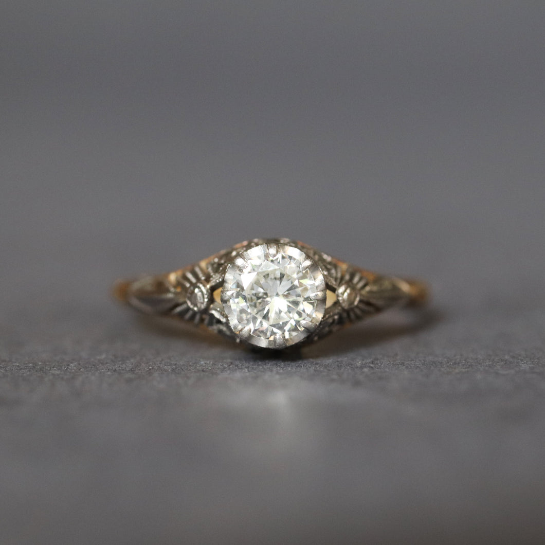 Antique diamond solitaire ring. Prong setting. Openwork gallery. Platinum and gold band. Cathedral. Round early brilliant cut. Antique engagement ring.