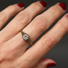 Load image into Gallery viewer, Antique diamond solitaire ring. Prong setting. Openwork gallery. Platinum and gold band. Cathedral. Round early brilliant cut. Antique engagement ring.
