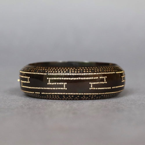 Antique Victorian pique tortoiseshell bangle bracelet with gold Greek key and star pattern motif.