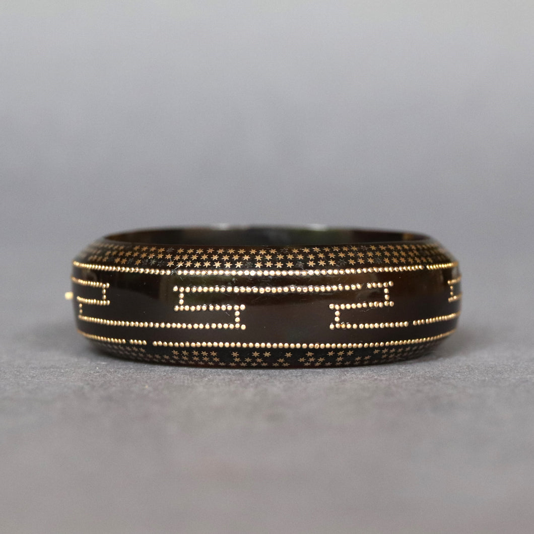Antique Victorian pique tortoiseshell bangle bracelet with gold Greek key and star pattern motif.