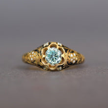 Load image into Gallery viewer, Antique Victorian era mourning ring set with a blue topaz in a belcher setting to an 18ct gold band with black enamel and white forget me nots. Solitaire ring.
