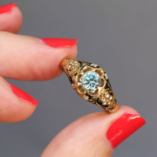 Load image into Gallery viewer, Antique Victorian era mourning ring set with a blue topaz in a belcher setting to an 18ct gold band with black enamel and white forget me nots. Solitaire ring.

