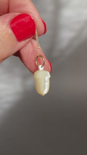 Antique victorian era acorn pendant charm carved from mother of pearl with a gold jumper ring. Symbol of growing love.
