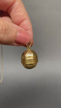 Load and play video in Gallery viewer, Antique Victorian era oval-shaped pendant in 15ct gold with repousse and foliate engraving. Locket spins to reveal hidden secret glass compartment.
