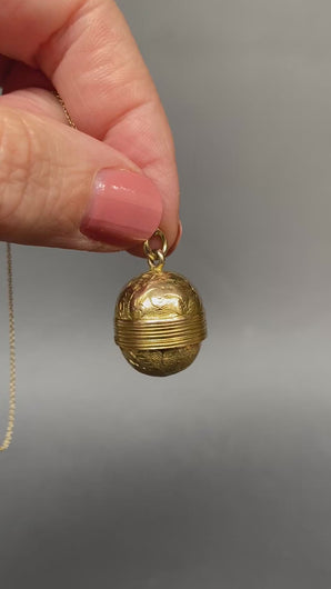 Antique Victorian era oval-shaped pendant in 15ct gold with repousse and foliate engraving. Locket spins to reveal hidden secret glass compartment.
