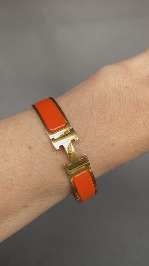Vintage Hermes yellow gold bangle bracelet. Hermes clic clac. Hermes Clic H bracelet in orange enamel. Size small.