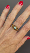 Load and play video in Gallery viewer, Antique Victorian era mourning ring set with a blue topaz in a belcher setting to an 18ct gold band with black enamel and white forget me nots. Solitaire ring.

