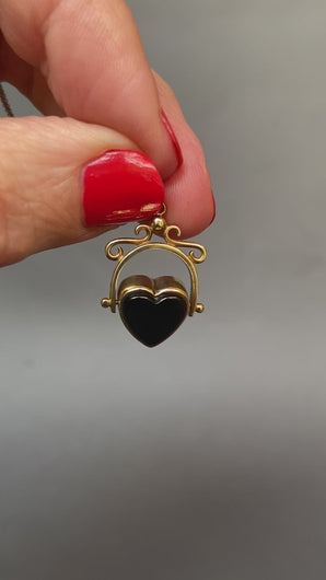 Vintage heart-shaped spinner fob pendant with rotating heart set with onyx and bloodstone in a 9ct yellow gold arched frame.