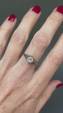 Load and play video in Gallery viewer, Antique diamond solitaire ring. Prong setting. Openwork gallery. Platinum and gold band. Cathedral. Round early brilliant cut. Antique engagement ring.
