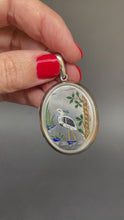 Load and play video in Gallery viewer, Antique Aesthetic movement locket dating to the Victorian era with engraved wading stork and songbird in multicoloured enamel. Oval locket. Birth present. Baby gift. Push present.
