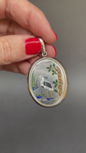 Antique Aesthetic movement locket dating to the Victorian era with engraved wading stork and songbird in multicoloured enamel. Oval locket. Birth present. Baby gift. Push present.