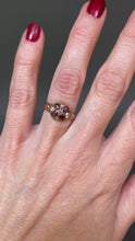 Load and play video in Gallery viewer, Antique Victorian era cluster ring with oval cut garnets and old cut diamonds in a flower design with a rose gold band.
